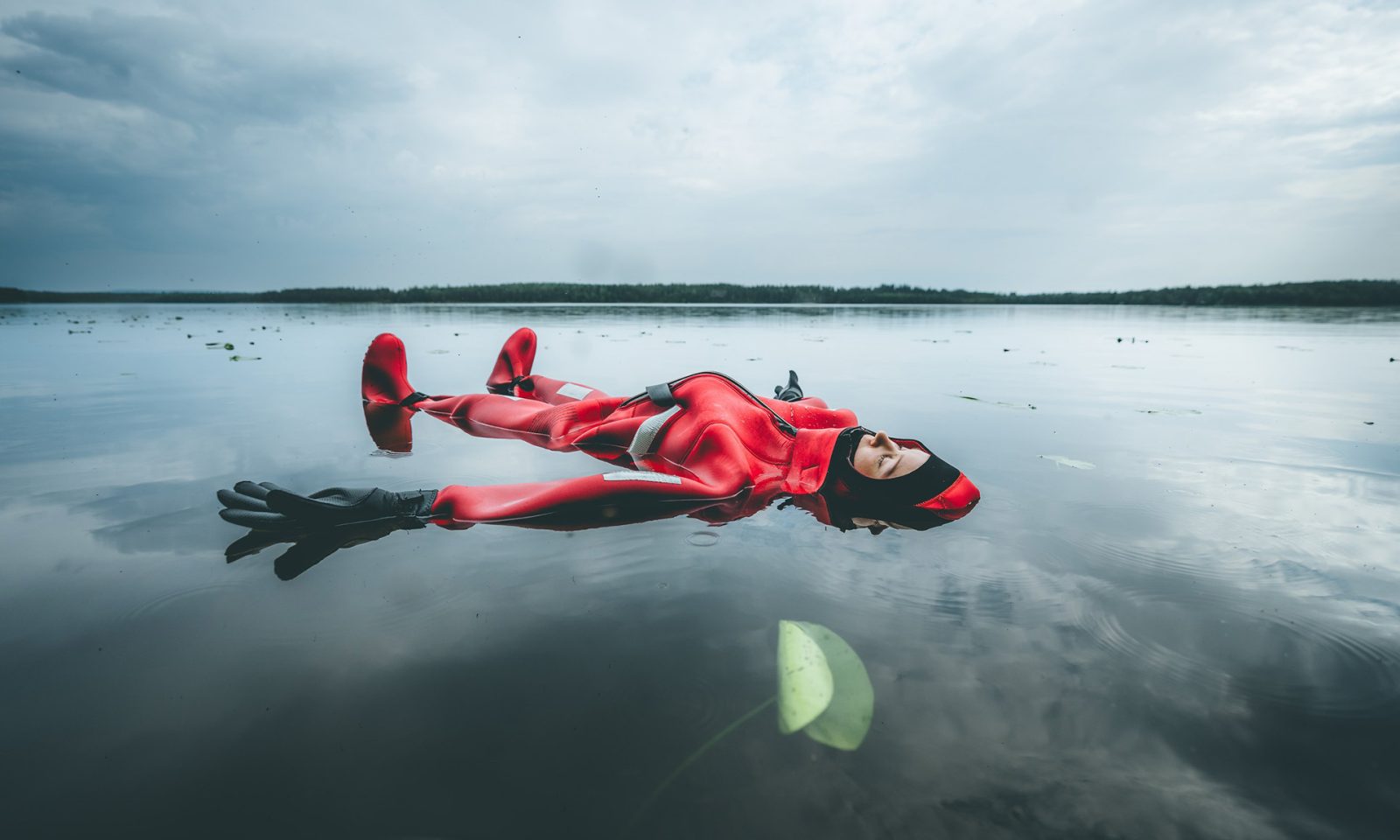 Woman having relaxing Arctic Floating experience provided by Arctic TreeHouse Hotel.