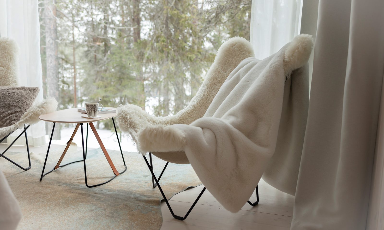 Two armchairs in front of the window in the Arctic TreeHouse Suite's lounge.