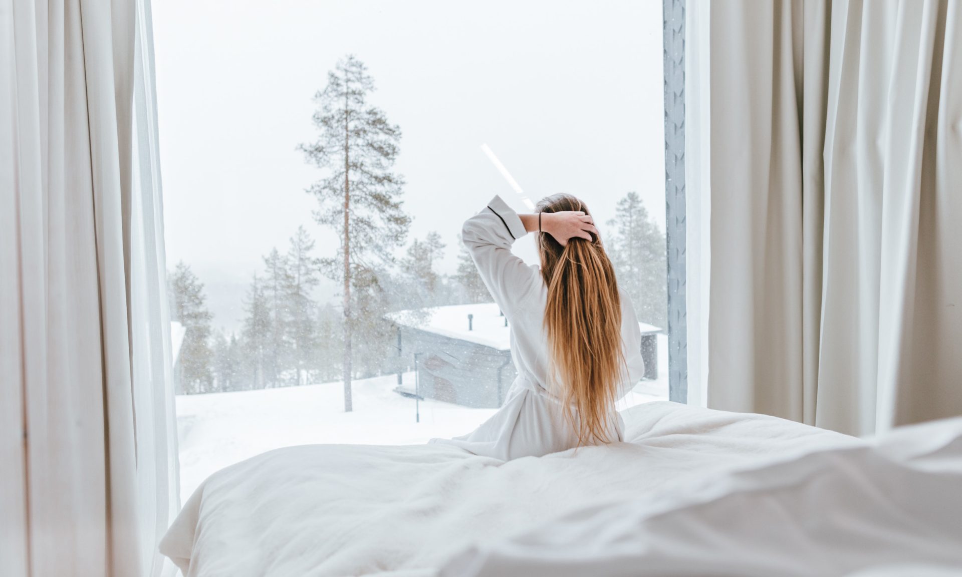 A woman enjoying the view in her suite.