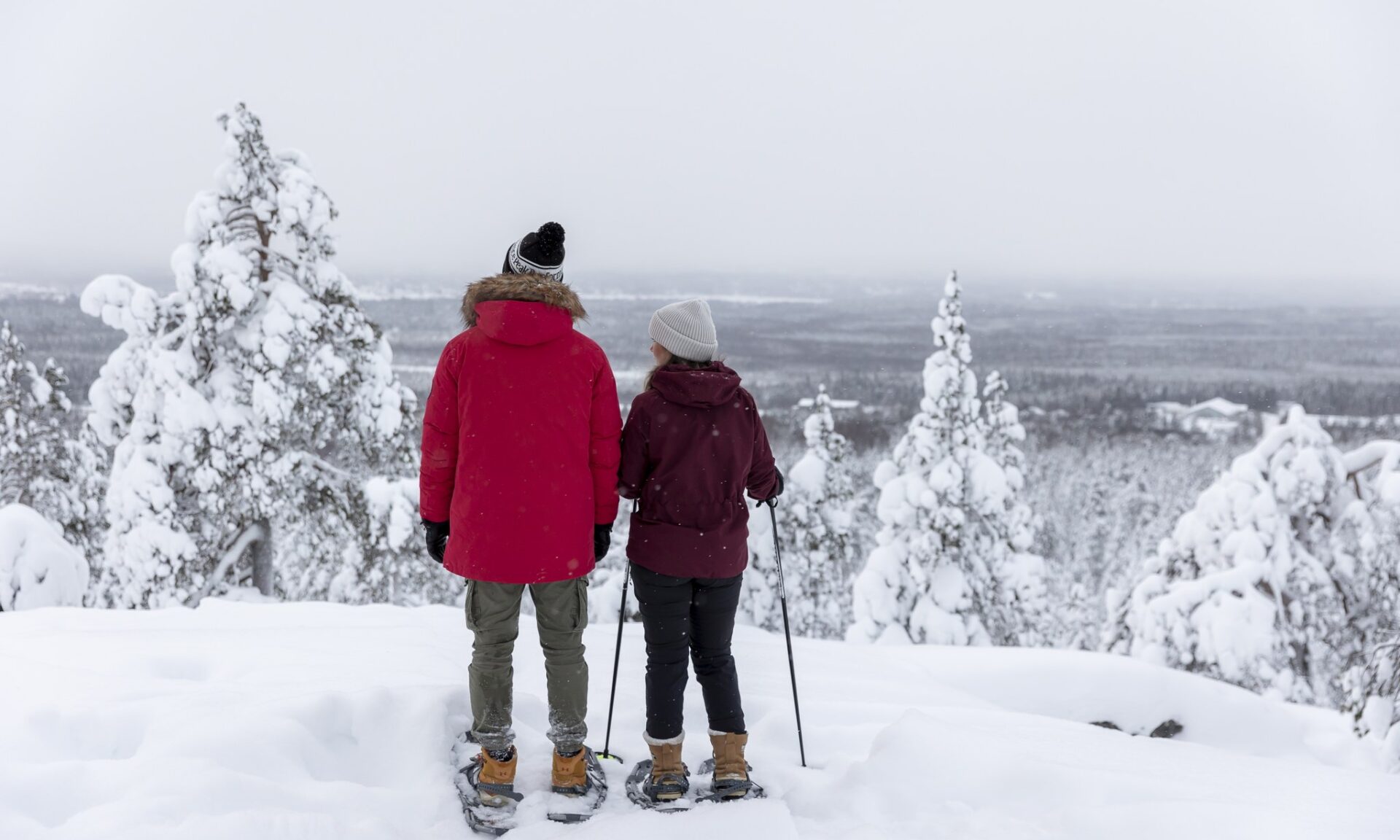 Couple enjoying snowshoeing in the wintry nature. Rovaniemi, Lapland, Finland.