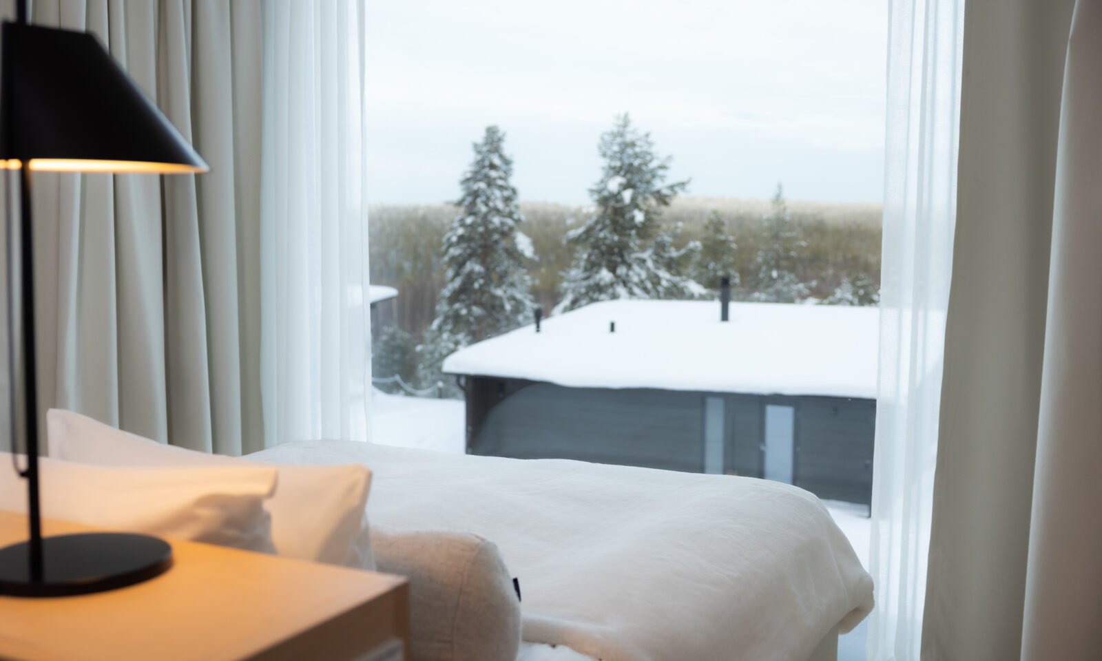 Double bed facing north at Arctic Scene Executive suite in winter at Arctic TreeHouse Hotel.