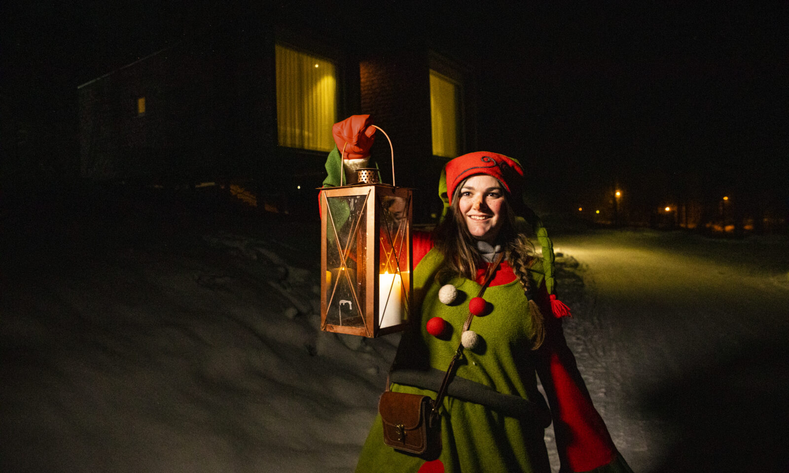Elf front of the Arctic TreeHouse Hotel suite.