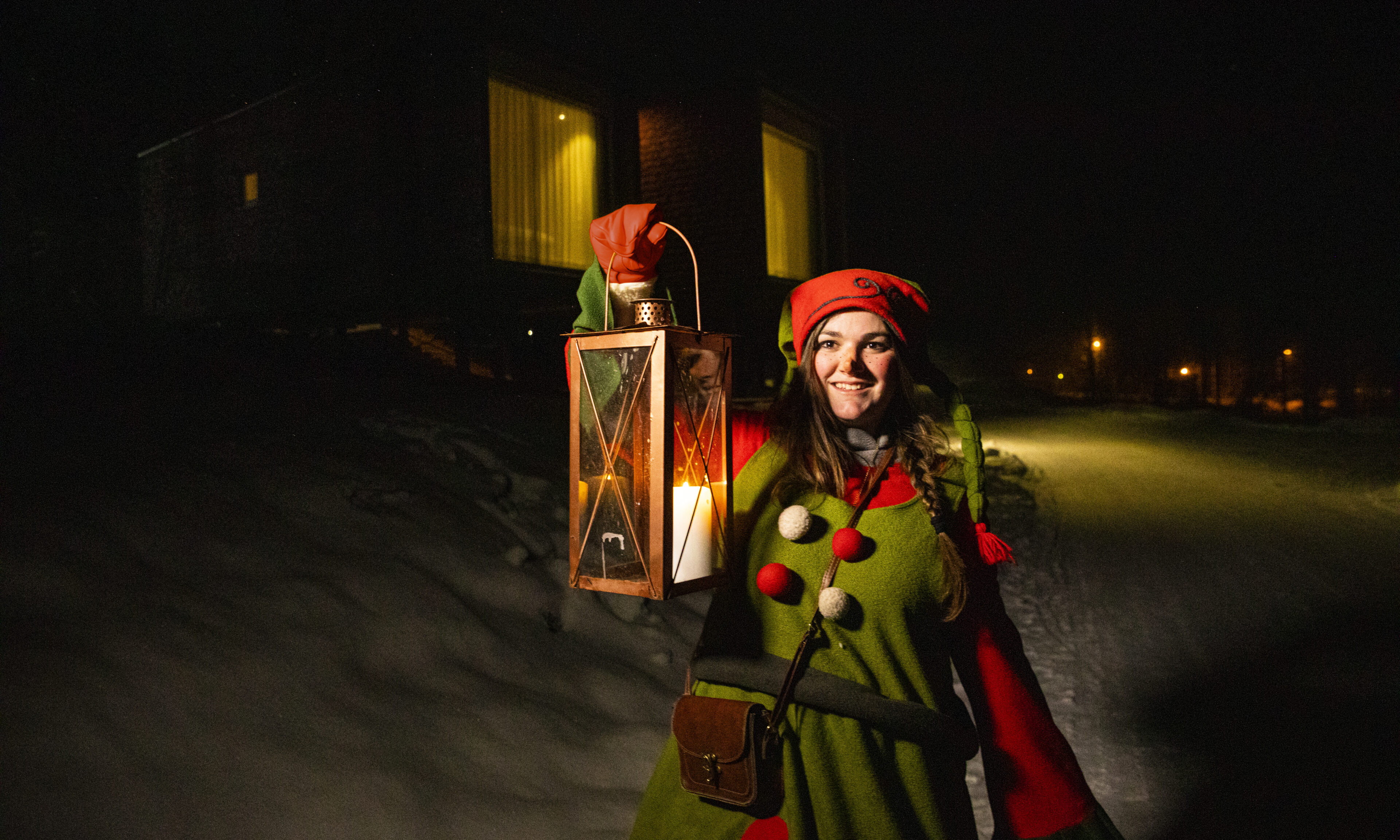 Elf front of the Arctic TreeHouse Hotel suite.